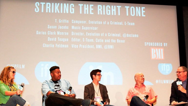 Panelists and moderator engaged in conversation at the “Striking the Right Tone