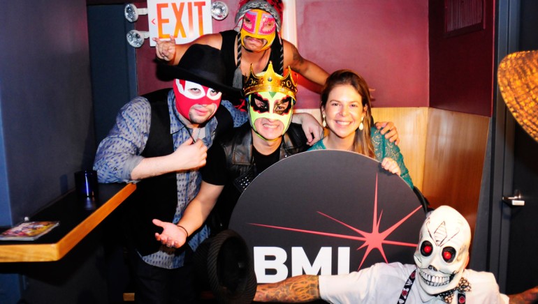 Los Chinchillos Del Caribe grab their masks and strike a pose backstage with BMI’s Carolina Arenas at BMI’s Verano Alternativo on July 7, 2014.