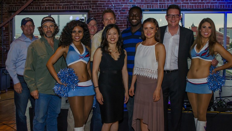(L-R): BMI songwriters Shane Minor, Casey Beathard, and Phil O'Donnell with BMI’s Perry Howard, Titans’ Moise Fokou, PR rep Jane Yin, songwriter Cora Keller and Titans cheerleaders support the Root 53 Foundation Event.