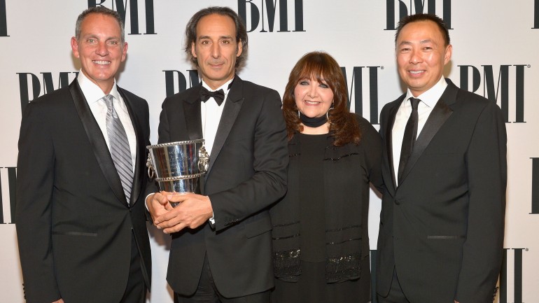 (L-R) BMI President and CEO Mike O’Neill, honoree Alexandre Desplat, BMI Vice President of Film and Television Relations Doreen Ringer-Ross and Assistant Vice President of Film and Television Relations at BMI Ray Yee pose with the BMI Icon Award during the 2015 BMI Film & Television Awards. 
