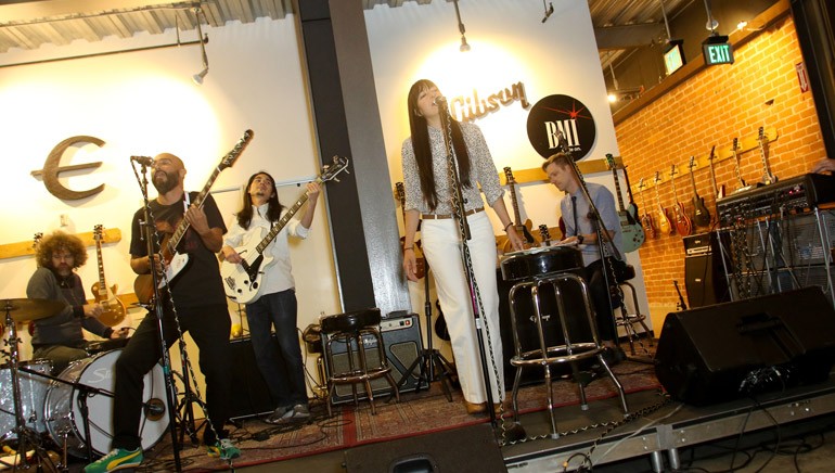 (L-R): Los Dreamers on stage during a special performance at the Gibson Brands Showroom.