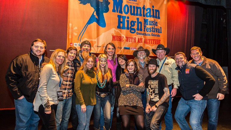 BMI executives and songwriters pose in front of the banner for the inaugural Mountain High Music Festival. BMI songwriter and 2013 Country Icon Dean Dillon was the host of the event.