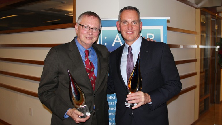peermusic’s Ralph Peer II and BMI President and CEO Mike O’Neill with their awards at AIMP’s holiday event.