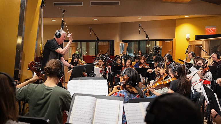 Composer Alan Silvestri conducts a student orchestra recording session during Annual BMI Day at the Berklee College of Music.