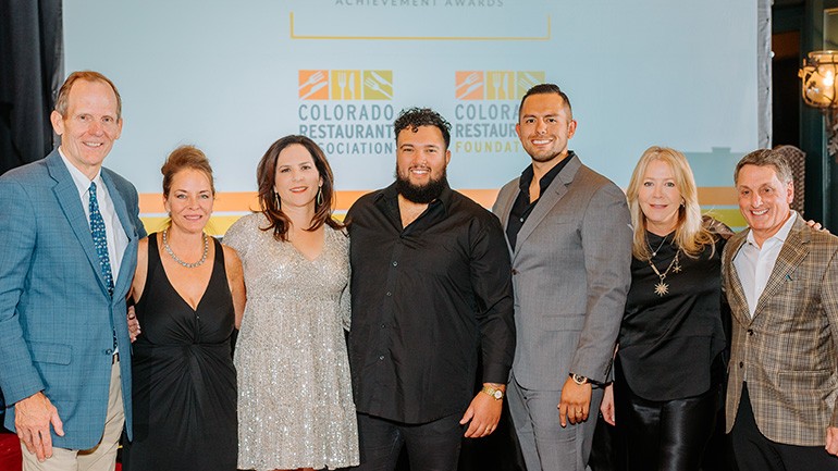 Pictured before BMI songwriter Trey Simon’s performance at the CRA Lifetime Achievement Awards (L to R): BMI’s Dan Spears, Crafted Concepts owner, and Lifetime Achievement winner Beth Gruitch, Colorado Restaurant Association CEO Sonia Riggs, BMI songwriter Trey Simon, Ramirez Hospitality Group Co-CEO and CRA Board Chair Daniel Ramirez, Colorado Restaurant Association VP of Strategic Partnerships Devaney McNeill, Shanahan’s Steakhouse Managing Partner, and Lifetime Achievement winner Marc Steron.