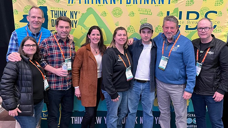 Pictured before BMI songwriter Elijah Wolf hits the stage at the 2024 NY State Craft Brewers Conference in Albany (l to r): Interboro Spirits and Ales CEO/co-founder Laura Dierks, BMI’s Dan Spears, Resurgence Brewing Company founder/owner Jeff Ware, Wild East Brewery co-founder Lindsay Steen, Lunkenheimer Craft Brewing Company co-founder Kristen Lunkenheimer, BMI songwriter Elijah Wolf, Greenport Harbor Brewing Company co-founder and past NYSBA Board Chair Rich Vandenburgh, NYSBA Executive Director Paul Leone.