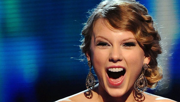 Taylor Swift accepts one of four trophies during the 52nd Annual Grammy Awards.