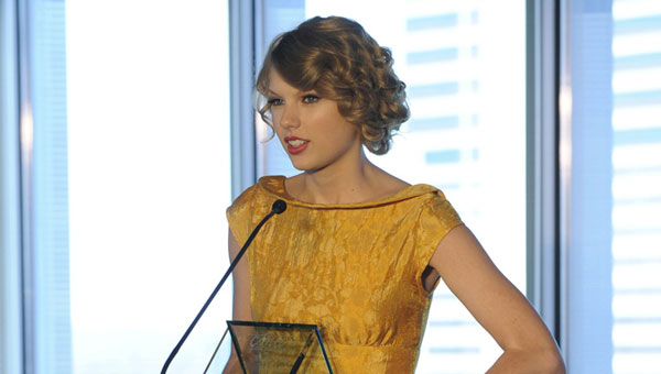 Taylor Swift accepts her Triple Play Award at this year's CMA Songwriters Luncheon.