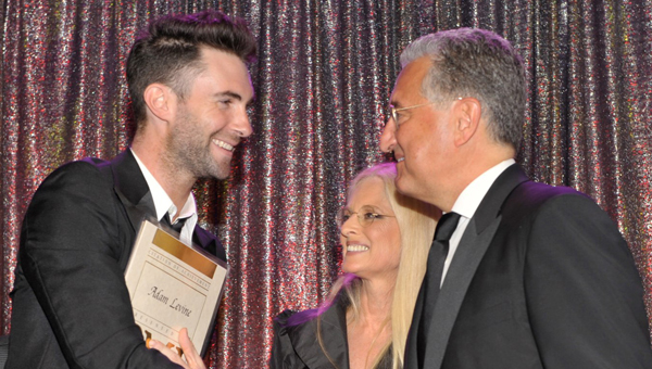 Onstage at the 2009 BMI Pop awards is Maroon 5's Adam Levine with BMI's Barbara Cane and BMI's CEO Del Bryant.