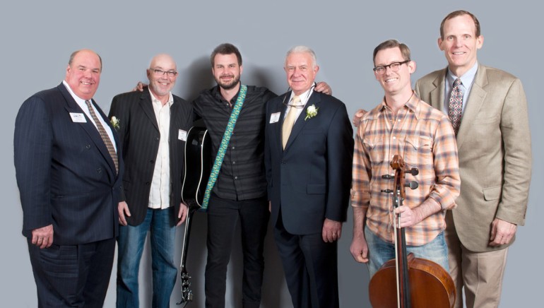 Pictured after Howie’s performance (l to r): MRA Board Chair and owner of King Eider’s Pub & Restaurant Todd Maurer,  Owner of Nicky’s Crusin’ Diner Howie Day, Sr., Howie Day,  MRA President Dick Grotton, Cellist Ward Williams and BMI’s Dan Spears.