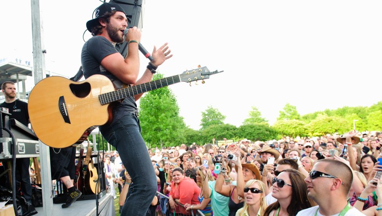 Pictured: Thomas Rhett performs at the BMI Tailgate Party outside LP Field during the 2013 CMA Music Festival on June 6, 2013, in Nashville, TN.