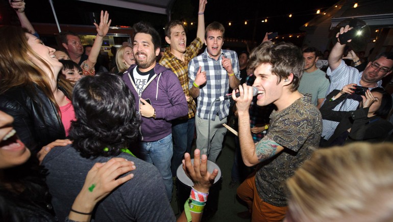 Pictured: Royal Teeth's Gary Larsen performs amidst the crowd at the BMI Indie/Rock showcase at Bar 96 during SXSW on March 14, 2013, in Austin, TX.