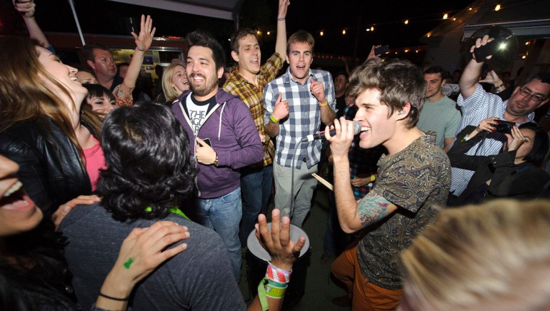 Pictured: Royal Teeth's Gary Larsen performs amidst the crowd at the BMI Indie/Rock showcase at Bar 96 during SXSW on March 14, 2013, in Austin, TX. 