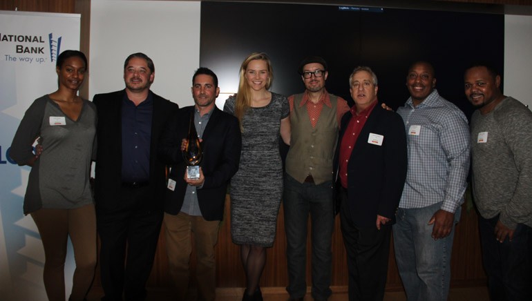 Pictured at the 2014 AIMP holiday party held at BMI’s Los Angeles office (L–R): ole Office Coordinator Lauren Carter; ole MusicBox SVP Steven Karpowicz;  ole VP, Business Development David Weitzman; ole Creative Manager Jennifer Essiembre; ole  Senior Manager, Synch and Licensing, Brandon Schott; ole MusicBox Director Film/TV Music Licensing Andrew Robbins; ole | BlueStone Director, Eric Spence and Mosley Music Group President Marcus Spence.