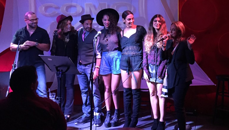 BMI’s Joey Mercado, Karen Inderbitzin, Elsten Torres, Raquel Sofia, Manu Manzo, Camila Luna and BMI’s Delia Orjuela pose for a photo on stage during BMI’s Acoustic Lounge, held in Miami on October 14.