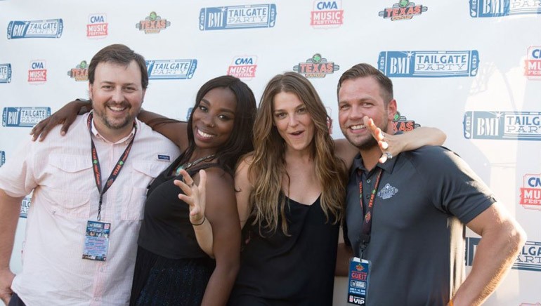 BMI’s Mason Hunter and BMI singer-songwriters Jessy Wilson and Kallie North of Muddy Magnolias pose with sponsor Texas Roadhouse’s Tyler Durham before the duo’s performance at the BMI Tailgate stage at CMA Fest.