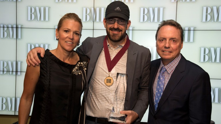 BMI’s Leslie Roberts (L) and Jody Williams (R) pose with Songwriter of the Year winner Chris Stevens. His most-played Christian radio hits include “Beautiful Day,” “Overcomer” and “Slip On By.”
