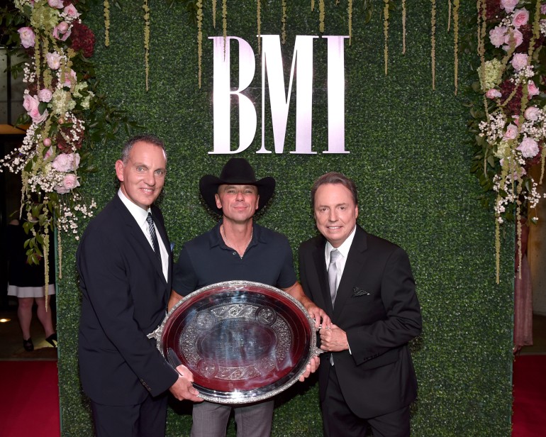 BMI President & CEO Mike O'Neill and BMI Vice President, Writer/Publisher Relations Jody Williams pose with 2016 President's Award recipient Kenny Chesney.