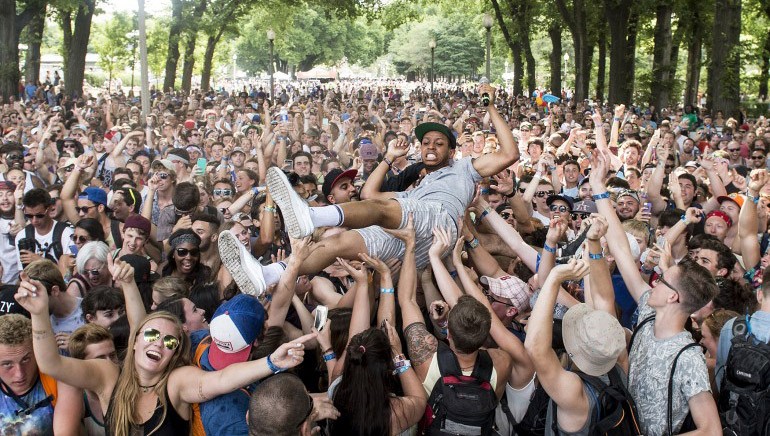 New Orleans rapper and BMI songwriter Pell joins the crowd during his set at the BMI stage during Lollapalooza in 2015.
