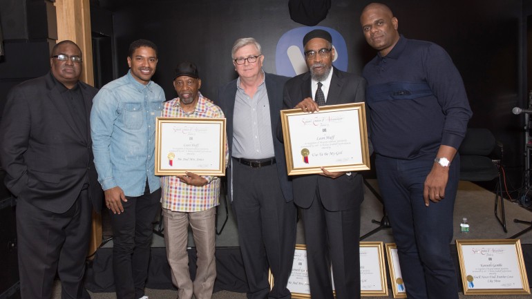 Pictured with two of their BMI Million-Air awards are: GRAMMY award-winning songwriters Leon Huff and Kenny Gamble with Chuck Gamble, Vice President, Catalog Promotions, Warner/Chappell Music (far left); Ryan Press, Co-Head, A&R, U.S., Warner/Chappell Music (second from left); Phil Graham, BMI Senior Vice President, Writer/Publishers Relations (center); and Jon Platt, Chairman and CEO, Warner/Chappell Music (far right). 