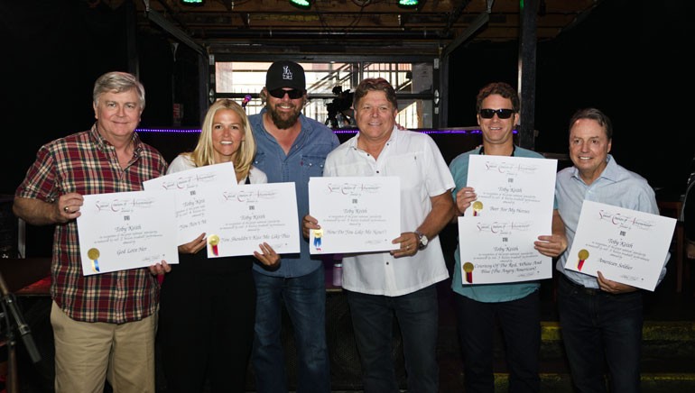 Pictured: (L-R): BMI’s Phil Graham and Leslie Roberts, BMI singer-songwriter Toby Keith, BMI’s David Preston, BMI songwriter Scotty Emerick and BMI’s Jody Williams pose together after the presentation of Million-Air awards to Toby. The seven songs awarded totaled 23 million radio plays.