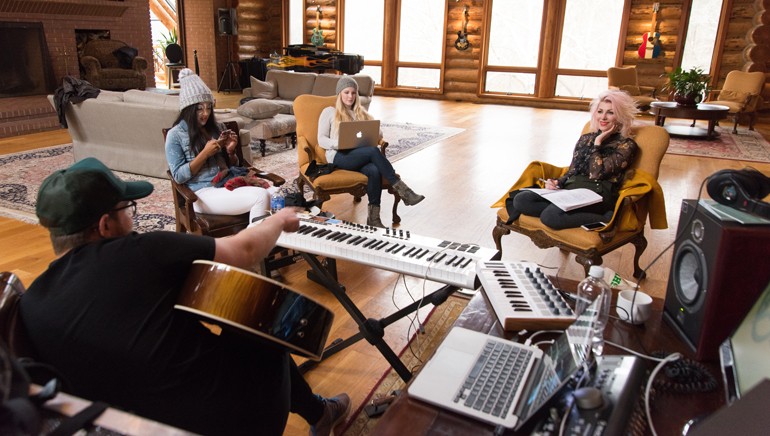Pictured: (L to R):  BMI songwriters Jordan Reynolds, Mickey Guyton, Sara Haze and Bonnie Mckee collaborate on a new track, using all available resources from the high-tech computer to low-tech notebook and instruments including guitar and piano.