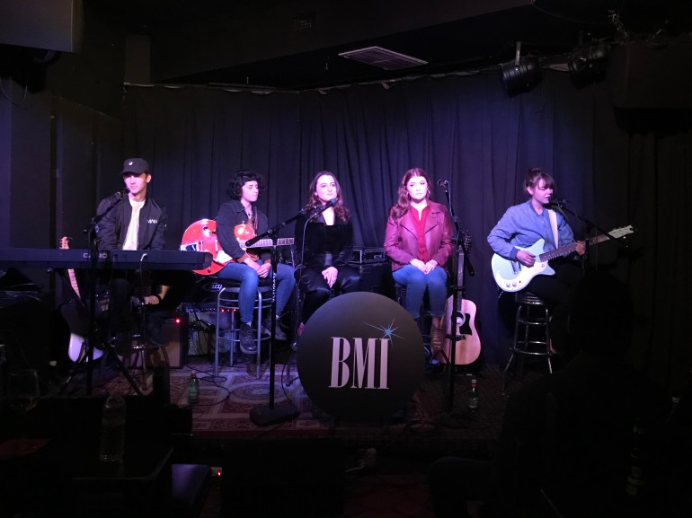 (L-R): Cody Johns, Jess Kallen, Kendra Calhoun and Paige Shannon listen as Madeleine Mayi (far right) takes her turn at the mic at the December edition of BMI’s Acoustic Lounge at Genghis Cohen in Los Angeles.