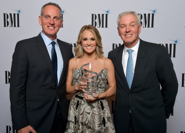 Mike O’Neill, President and CEO of BMI and Paul Karpowicz, Chairman, BMI Board of Directors & President, Meredith Local Media Group, present Carrie Underwood with the BMI Board of Directors Award at the 69th Annual BMI/NAB Dinner.