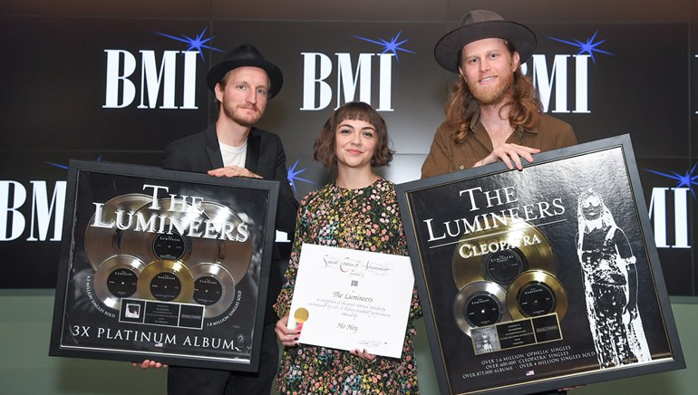 The Lumineers display their plaques and Million-Air awards.