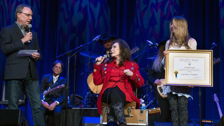 Pictured: BMI’s Jody Williams presents legendary BMI songwriter Loretta Lynn with a Million-Air award with help from BMI’s Mary Loving.