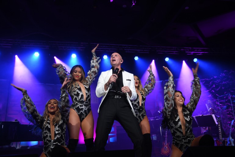 Global Ambassador Award recipient Pitbull closes the night with a high-energy performance.