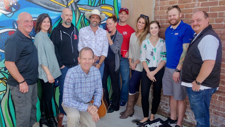 Pictured after the Tavern League of Colorado music licensing seminar and Clint Daniels’ performance are (standing): Tavern League of Colorado Associate Director David Reitz, Tavern Hospitality Group Director of Marketing Helen Wood, Soiled Dove Underground Talent Buyer Rhett Lee, BMI songwriter Clint Daniels, Rio Grande Restaurant Group Executive, Little Pub Company owner Mark Berzins, Tavern Hospitality Group Director of Group Sales & Events Vanessa Miranda, Tavern League of Colorado Executive Director Stephanie Fransen, Lodo’s Downtown General Manager Eric Gustafson, Tavern Hospitality Group Pres & CEO Gary Mantelli. (kneeling): BMI’s Dan Spears