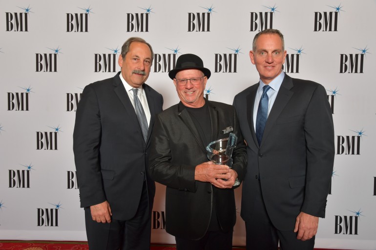 Michael Fiorile, Chairman of the BMI Board of Directors and Mike O’Neill, President and CEO of BMI present Mike Post with the BMI Board of Directors Awards at the 70th Annual BMI/NAB Dinner.