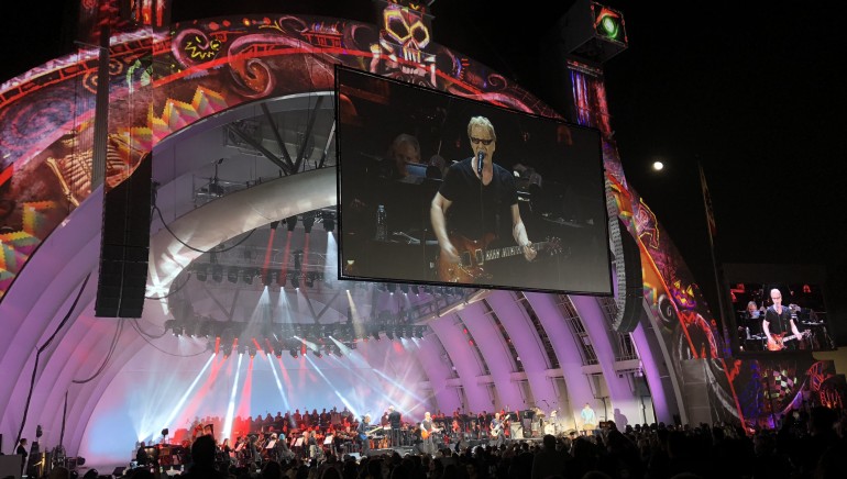 Elfman straps on his guitar for a performance of “Dead Man’s Party” with Oingo Boingo.