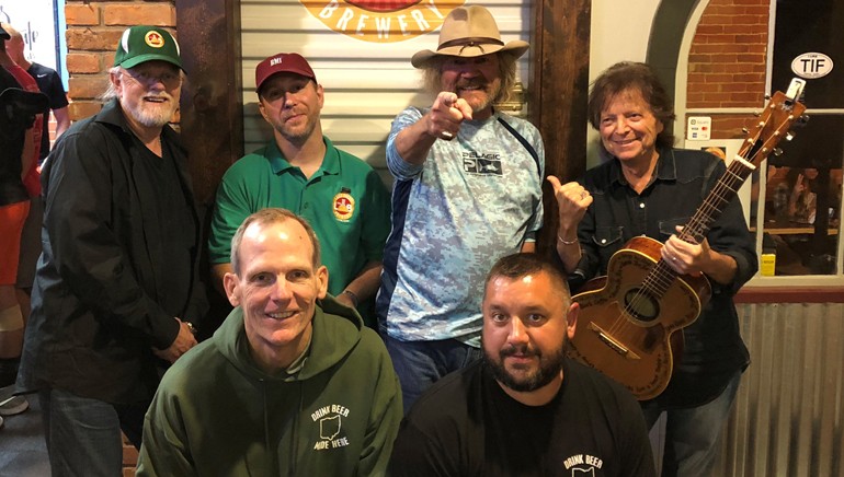 Pictured (L-R) before the performance at The Laird Arcade Brewery in Tiffin, OH are (standing): BMI songwriter Aaron Barker, The Laird Arcade Brewery co-owner Eric Kuebler and BMI songwriters Earl Bud Lee and Even Stevens. (Kneeling):  BMI’s Dan Spears and The Laird Arcade Brewery co-owner Andy Flechtner.
