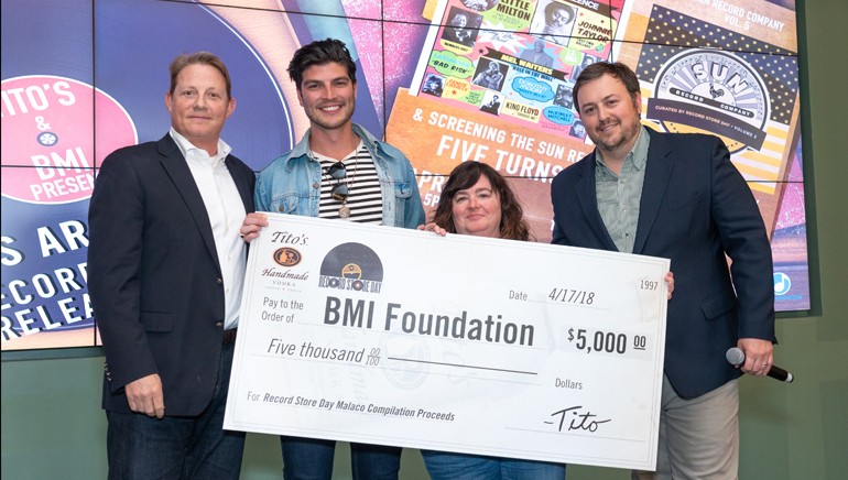 The BMI Foundation’s Clay Bradley, Tito’s Zack Flores, Record Store Day’s Carrie Colliton and BMI’s Mason Hunter pose with Tito’s and Record Store Day’s donation check to the BMI Foundation.