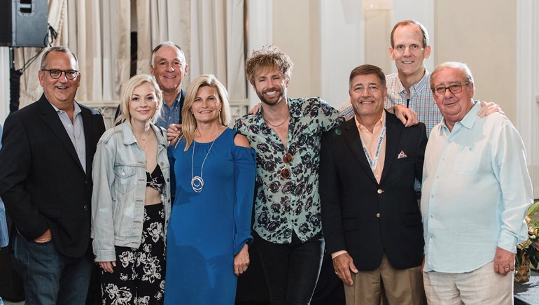 Gathered (L-R) for a photo before the performance at the Florida Association of Broadcasters annual conference are: Univision Station Group Senior Vice President and Regional Director and FAB outgoing Board Chair Luis Fernandez-Rocha, BMI songwriter Emily Kinney, Holladay Broadcasting President/Owner and the 2018 FAB Bill Brooks Award-winner Bob Holladay, Holladay Broadcasting Vice President of Sales Sherri Holladay, BMI songwriter Paul McDonald, Sinclair Broadcast Group Market Manager-West Palm Beach and FAB Board Chair Mike Pumo, BMI’s Dan Spears and FAB Pres/CEO Pat Roberts.
