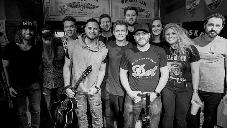 Dallas Wilson, Jeffrey East, Adam Hall, FILMORE, BMI's Josh Tomlinson, Levi Hummon, Adam Doleac, Whiskey Jam's Ward Gunter, BMI's MaryAnn Keen, Faren Rachels and Derek Wells gather for a photo onstage during BMI’s Whiskey Jam takeover.