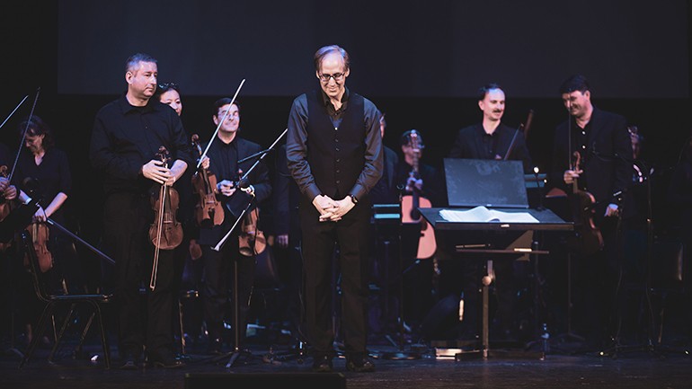 Composer Jeff Beal takes a bow to a standing ovation at the Wiltern at the end of the Biggest Little Farm Live concert.
