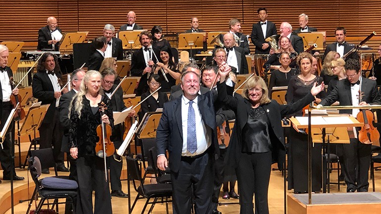 BMI composer Lucas Richman receives thundering applause on stage with the conductor of the Los Angeles Jewish Symphony, Noreen Green.