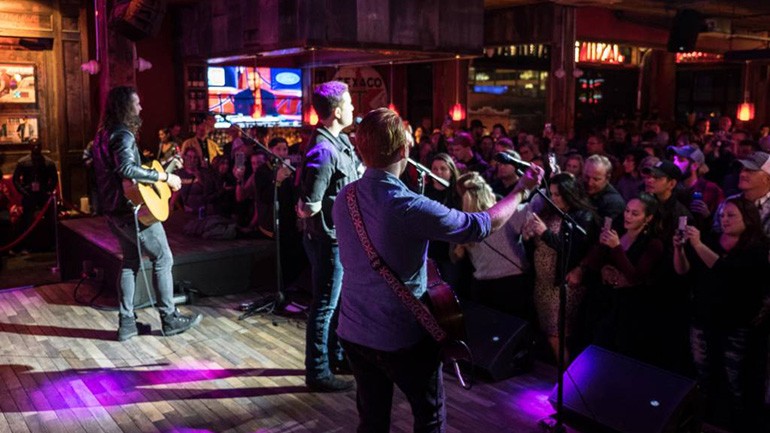 Scotty McCreery address the special audience of veterans and their families and friends at the “iHeartCountry: One Night for Our Military” BMI Guitar Pull at Jason Aldean’s Kitchen in Nashville.