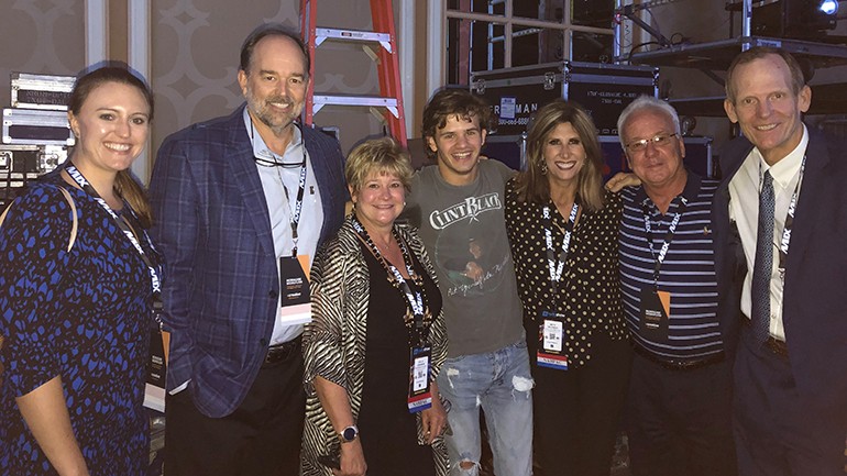 Pictured (L-R) after BMLG recording artist Payton Smith’s performance at the 2019 Radio Show are: Butte Broadcasting’s Maggie Davis, Guaranty Broadcasting President Flynn Foster, Louisiana Association of Broadcasters President/CEO Polly Johnson, BMI songwriter Payton Smith, North Dakota Broadcasters Association Executive Director Beth Helfrich, Missouri Association of Broadcasters Director of MO-PEP Frank Forgey and BMI’s Dan Spears.