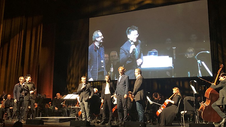Composers Jesper Kyd and Sarah Schachner are introduced to the crowd by actor Roger Craig Smith, who voices the main character, Ezio, from “Assassin’s Creed.”