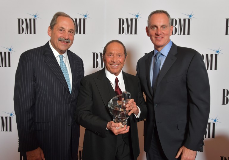 Michael Fiorile, Chairman, BMI Board of Directors & Chairman and CEO, The Dispatch Printing Company and BMI President and CEO Mike O’Neill present Paul Anka with the BMI Board of Directors Award at the 71st Annual BMI/NAB Dinner.