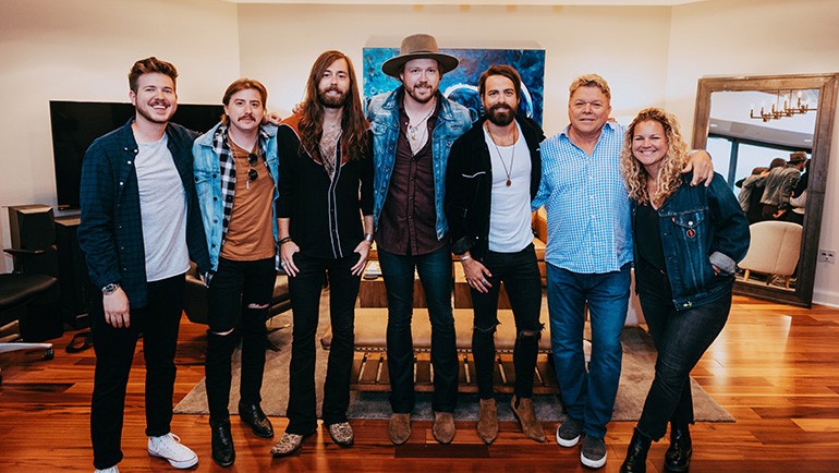 BMI’s Josh Tomlinson, David Preston and Nina Carter pose backstage with A Thousand Horses.