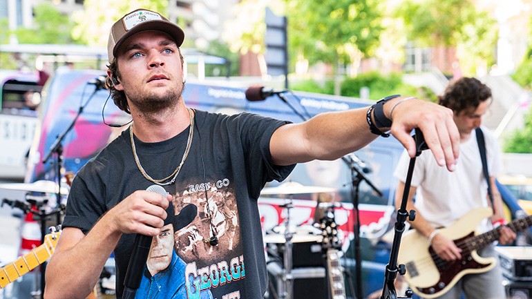 Conner Smith looks out at his many fans during his set at the Ryman Block Party Powered by BMI during the 2022 CMA Fest.