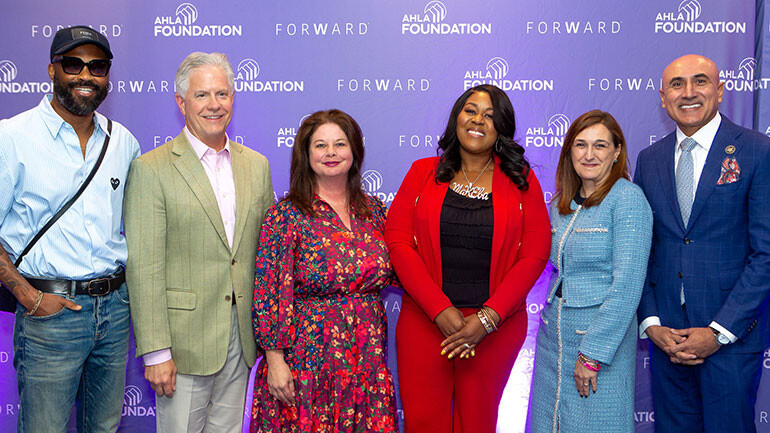 Pictured with BMI singer, songwriter and producer Makeba Riddick-Woods after her performance and interview with BMI’s Jessica Frost (l to r): BMI’s Wardell Malloy, AH&LA COO & AH&LA Foundation President & CEO Kevin Carey, BMI’s Jessica Frost, BMI singer, songwriter, and producer Makeba Riddick-Woods, AH&LA President & CEO Rosanna Maietta, AH&LA Chair of the Board & Vision Hospitality Group President & CEO Mitch Patel.