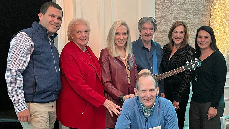 Pictured before Terry Sylvester of the Hollies performed at the 2024 ISHA Winter Meeting (Left to Right): Standing:   Illinois Hotel & Lodging Association CEO Michael Jacobson, Florida Restaurant & Lodging Association Director of Membership & ISHA Board Chair Dannette Lynch,  Florida Restaurant & Lodging Association CEO Carol Dover, The Hollies’ Terry Sylvester, North Carolina Restaurant & Lodging Association Lynn Minges, ISHA Executive Director Chris Pappas. Kneeling: BMI’s Dan Spears.