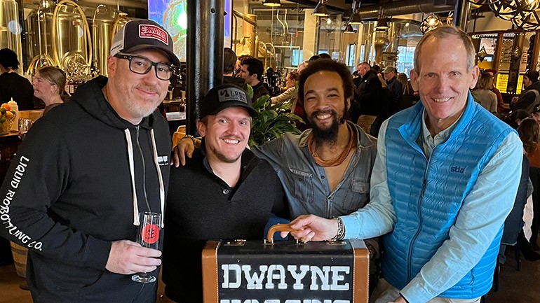 Pictured before the Dwayne Haggins Band hits the stage at the New England Brew Summit after party at Liquid Riot in Portland (L to R):  Liquid Riot Bottling Company Vice President of Operations Matthew Marrier, Liquid Riot Bottling Company General Manager Cody Sutton, BMI songwriter Dwayne Haggins, BMI’s Dan Spears.