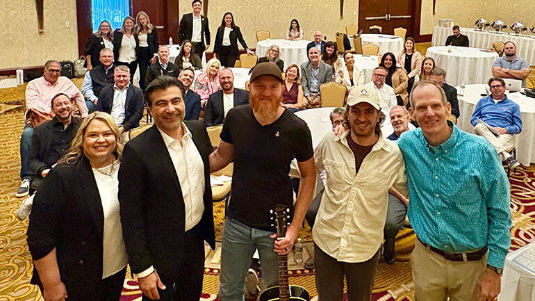 BMI songwriter Eric Paslay pictured with the board of the Rhode Island Hospitality Association (standing L to R): RIHA COO Heather Singleton, RIHA CEO Farouk Rajab, BMI songwriter Eric Paslay, President of GHospitality and RIHA Board Chair Colin Geoffrey, BMI’s Dan Spears.